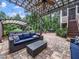 Inviting patio with stone flooring, pergola with ceiling fan, outdoor furniture and spa covered by pergola at 218 Inwood Forest Dr, Raleigh, NC 27603