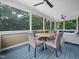 Cozy screened porch with outdoor dining set and comfortable seating area at 218 Inwood Forest Dr, Raleigh, NC 27603