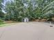 Private tennis court complete with basketball hoop in lush backyard setting at 218 Inwood Forest Dr, Raleigh, NC 27603