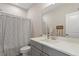 Well-lit bathroom featuring a gray vanity, white countertops, and a shower with patterned curtain at 223 Chauncey Cir, Chapel Hill, NC 27516