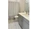 Modern bathroom with gray vanity and shower with patterned curtain at 223 Chauncey Cir, Chapel Hill, NC 27516