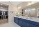 Bathroom with double sink vanity, large mirror, and walk-in closet at 223 Chauncey Cir, Chapel Hill, NC 27516