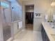 Luxurious bathroom featuring a glass-enclosed shower and double vanity sinks, with a walk-in closet at 223 Chauncey Cir, Chapel Hill, NC 27516