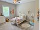 Charming bedroom featuring a playful decor, a cozy bed, and natural light at 223 Chauncey Cir, Chapel Hill, NC 27516