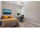 Cozy bedroom featuring a bed, desk, and a large window at 223 Chauncey Cir, Chapel Hill, NC 27516