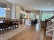Bright dining area with a large window, wooden table, and chairs, adjacent to the modern kitchen and living room at 223 Chauncey Cir, Chapel Hill, NC 27516