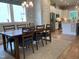 Bright dining area with a large window, wooden table, and chairs, adjacent to the modern kitchen at 223 Chauncey Cir, Chapel Hill, NC 27516