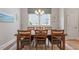 Cozy dining room with wood floors and a modern light fixture above a table at 223 Chauncey Cir, Chapel Hill, NC 27516