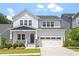 Charming two-story home boasts a manicured lawn and attached garage with a traditional architectural style at 223 Chauncey Cir, Chapel Hill, NC 27516