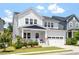 Charming two-story home boasts a manicured lawn and attached garage with a traditional architectural style at 223 Chauncey Cir, Chapel Hill, NC 27516