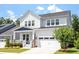 Charming two-story home boasts a manicured lawn and attached garage with a traditional architectural style at 223 Chauncey Cir, Chapel Hill, NC 27516