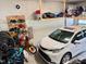 Organized garage with bikes, a white minivan, and overhead storage shelves at 223 Chauncey Cir, Chapel Hill, NC 27516