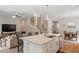 Modern kitchen with granite countertops, stainless steel appliances, and an island flows into the living room at 223 Chauncey Cir, Chapel Hill, NC 27516