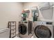 Well-equipped laundry room with washer and dryer, plus storage at 223 Chauncey Cir, Chapel Hill, NC 27516