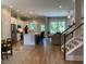 Spacious living room featuring an open floorplan with hardwood floors and staircase, and views of the kitchen at 223 Chauncey Cir, Chapel Hill, NC 27516