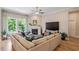 Comfortable living room with a fireplace, large windows, and hardwood floors offers a relaxing retreat at 223 Chauncey Cir, Chapel Hill, NC 27516
