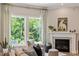 Cozy living room with a fireplace and view of the outdoors at 223 Chauncey Cir, Chapel Hill, NC 27516