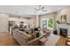 Cozy living room featuring a fireplace, plush seating, and seamless connection to the modern kitchen at 223 Chauncey Cir, Chapel Hill, NC 27516