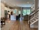 Spacious living room featuring an open floorplan with hardwood floors and staircase, and views of the kitchen at 223 Chauncey Cir, Chapel Hill, NC 27516
