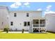Rear exterior view of home featuring a screened-in porch and outdoor patio at 223 Chauncey Cir, Chapel Hill, NC 27516