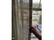 Close-up of window featuring light filtering shades and a glimpse of the outdoor landscape at 223 Chauncey Cir, Chapel Hill, NC 27516
