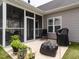 View of the backyard showing the outdoor patio and screened in porch at 2413 Whelen Dr, Graham, NC 27253
