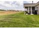 Backyard with lawn, landscaping, patio and screened-in porch at 2413 Whelen Dr, Graham, NC 27253