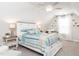 Airy bedroom boasts a ceiling fan, natural lighting, and coastal decor at 2413 Whelen Dr, Graham, NC 27253