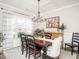 Bright dining room with large window, coffered ceiling, and hardwood floors at 2413 Whelen Dr, Graham, NC 27253