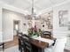 Elegant dining room with coffered ceilings, stylish chandelier and hardwood floors at 2413 Whelen Dr, Graham, NC 27253