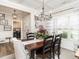 Dining room featuring natural lighting, chandelier, and view of laundry room at 2413 Whelen Dr, Graham, NC 27253