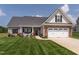 Charming two-story home with a manicured lawn and inviting curb appeal at 2413 Whelen Dr, Graham, NC 27253