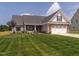 Inviting two-story home with a well-maintained lawn and attached two-car garage at 2413 Whelen Dr, Graham, NC 27253