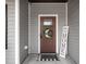 Stylish front door with a wreath, welcome sign, and a cozy entryway at 2413 Whelen Dr, Graham, NC 27253