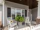 Inviting front porch featuring rocking chairs, a fern, and a welcoming ambiance at 2413 Whelen Dr, Graham, NC 27253