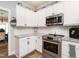 Kitchen featuring white cabinets, granite countertops and stainless appliances at 2413 Whelen Dr, Graham, NC 27253