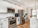 Well-lit kitchen featuring stainless appliances, white subway tile backsplash, and ample storage at 2413 Whelen Dr, Graham, NC 27253