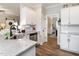Open kitchen featuring a view of the dining room with granite countertops and stainless dishwasher at 2413 Whelen Dr, Graham, NC 27253