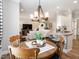 Open-concept living room showcases a round wood table and views of the living and kitchen areas at 2413 Whelen Dr, Graham, NC 27253