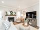 Cozy living room with fireplace, neutral decor, and plenty of natural light at 2413 Whelen Dr, Graham, NC 27253