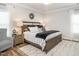 Bright main bedroom featuring a wooden bed frame, bedside tables, and a patterned area rug at 2413 Whelen Dr, Graham, NC 27253