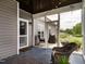 Screened in porch with rocking chair, string lights, and a view of the backyard at 2413 Whelen Dr, Graham, NC 27253