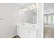 Bathroom featuring double vanity, mirror, and modern fixtures, leading to a bedroom at 2419 Pepperstone Dr, Graham, NC 27253