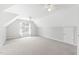 Spacious bedroom featuring sloped ceilings, carpet floors, and a window providing natural light at 2419 Pepperstone Dr, Graham, NC 27253