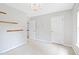 A bright bedroom featuring wood shelving, chandelier lighting and neutral carpeting at 2419 Pepperstone Dr, Graham, NC 27253