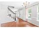 Inviting dining area with hardwood floors, chandelier, and natural light from the nearby window at 2419 Pepperstone Dr, Graham, NC 27253