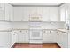 Bright kitchen featuring white cabinetry, granite countertops, and modern appliances at 2419 Pepperstone Dr, Graham, NC 27253