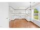 Spacious kitchen with white cabinets, granite countertops, and ample room for dining at 2419 Pepperstone Dr, Graham, NC 27253