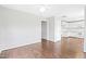 Spacious living room featuring hardwood floors, a ceiling fan, and access to the kitchen at 2419 Pepperstone Dr, Graham, NC 27253