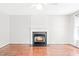 Cozy living room featuring hardwood floors and a charming fireplace with decorative mantle at 2419 Pepperstone Dr, Graham, NC 27253